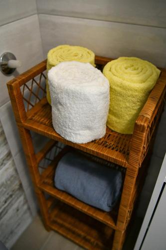 three towels on a shelf in a bathroom at Apartman Noa in Hrvace