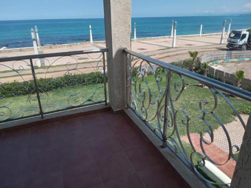 a balcony with a view of the ocean at IBAIA maison d'hôte in Fnidek