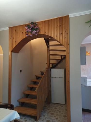 a wooden staircase in a room with a kitchen at Almavilla in Gyenesdiás