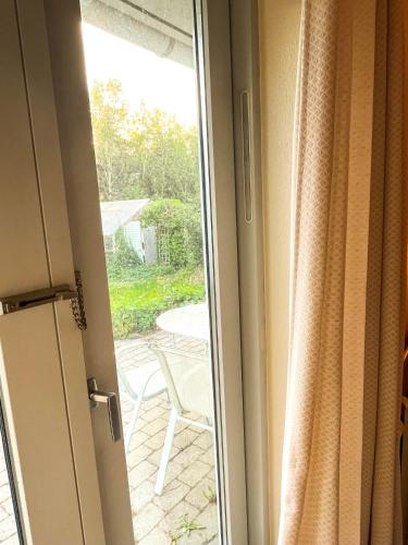 a sliding glass door with a view of a patio at Fred og Ro Ferielejlighed in Ulstrup