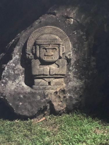 a stone statue of a head on a rock at Casa Natalie in Prado