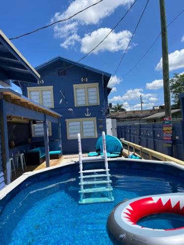 a swimming pool with a house in the background at Blue Little Havana in Miami