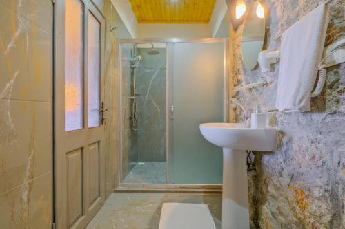 a bathroom with a shower and a sink at Faralya Yoruk Evi Suite in Faralya
