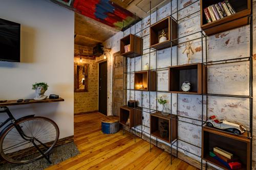 a room with a stone wall with a bike in it at Arthouse Narnia in Liepāja