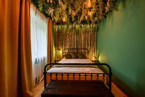 a bedroom with a bed in a room with a window at Arthouse Narnia in Liepāja