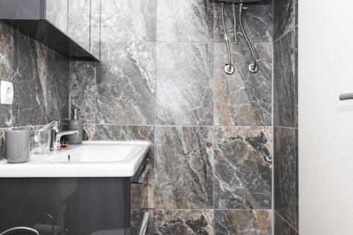 a bathroom with a sink and a shower at Heart of Dubrovnik Old Town apartments in Dubrovnik