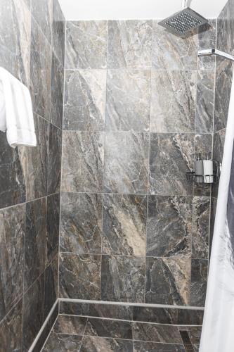 a bathroom with a large marble shower stall at Heart of Dubrovnik Old Town apartments in Dubrovnik