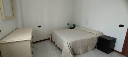 a small bedroom with a bed and a desk at Perugino Apartament in Florence