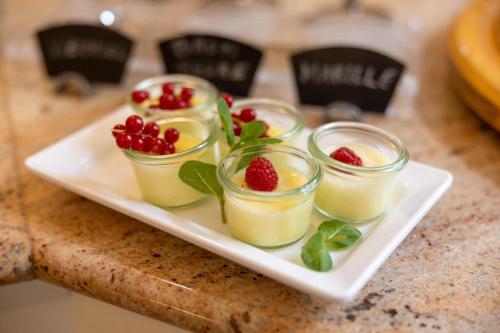 a white plate with four desserts on a table at Hotel Unter den Linden in Krems an der Donau