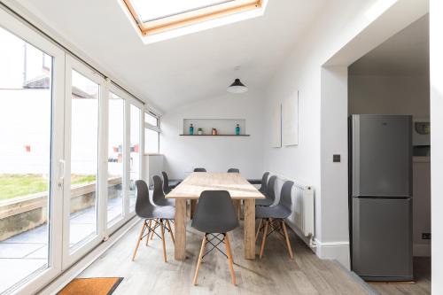 a kitchen and dining room with a table and chairs at Eden Cottage - 9 Guests, Sea Views, Central Cowes in Cowes