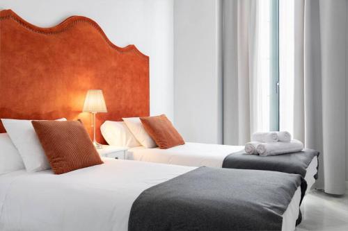 En eller flere senge i et værelse på San Buenaventura Apartment 3