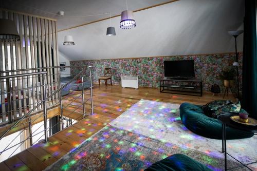 a living room with a couch and a flat screen tv at Kempings Ozolkalns in Cēsis