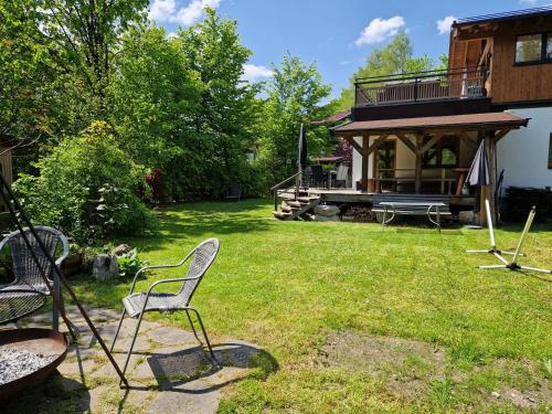 a yard with two chairs and a house at AlpinCreek in Leogang