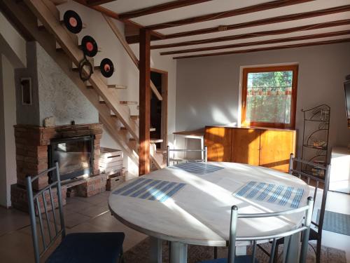 a living room with a table and a fireplace at Dom Jura Krakowsko- Częstochowska in Siedlec