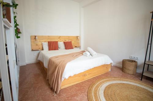 a bedroom with a large bed with a wooden headboard at The Village House in Machico