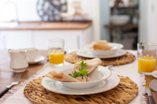 a table with plates and bowls of food on it at The Village House in Machico