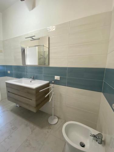 a bathroom with a sink and a toilet and a mirror at Villa Nausicaa San Felice Circeo in San Felice Circeo