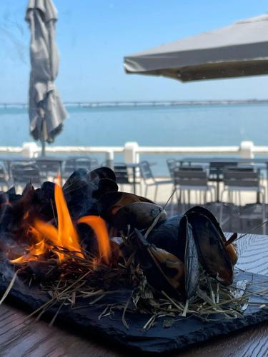 a pile of food sitting on top of a fire at Le Homard Bleu in Saint-Trojan-les-Bains