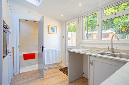 uma cozinha com um lavatório, uma janela e um chuveiro em Relax with the whole family at the cosy cottage - Business rates em Marlborough