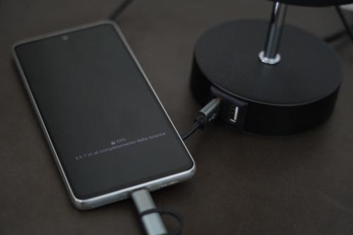 a cell phone is hooked up to a charger at le casette in Aradeo