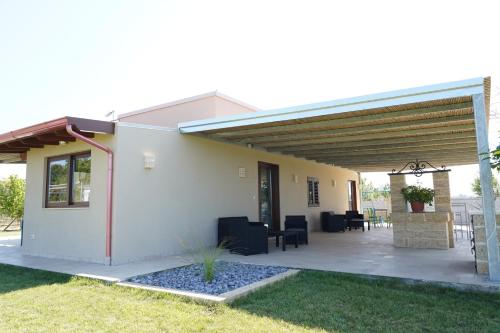 a patio of a house with awning at le casette in Aradeo