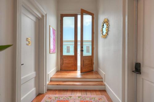 a hallway with a wooden door and a rug at Sugar's INN Room #6 King Bed in Galveston