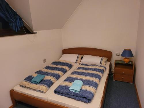 a bedroom with a bed with two towels on it at Appartement Camp Terme Čatež P93 in Čatež ob Savi