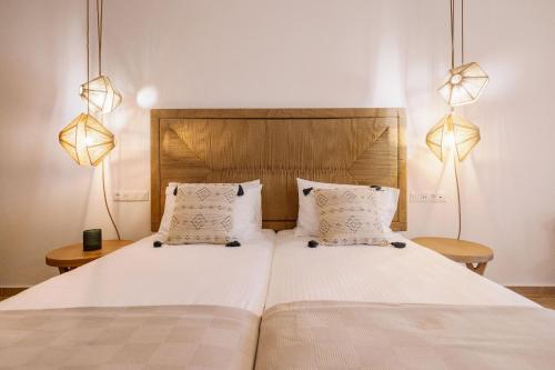 a bedroom with two beds and two lamps at Ariadne Hotel in Agios Prokopios