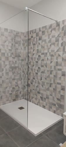 a shower with a glass door in a bathroom at Avó Lucindinha House - Porto Moniz in Porto Moniz