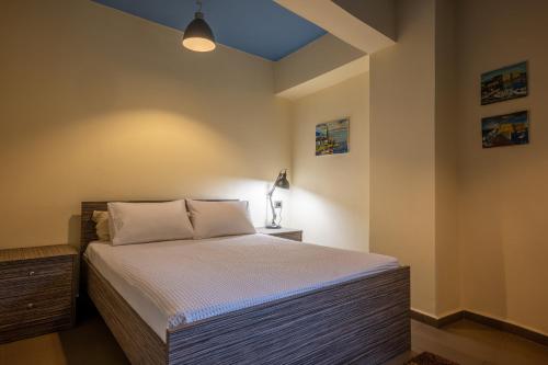 a bedroom with a bed and a blue ceiling at Kera valley house in Krásion