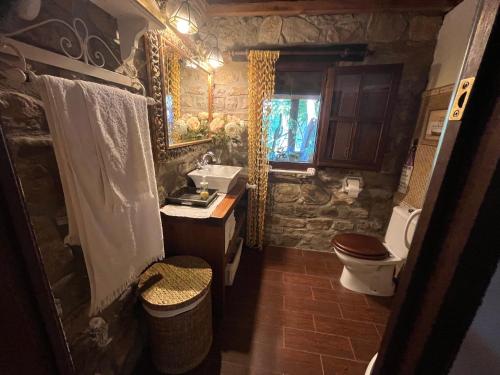 a bathroom with a sink and a toilet at Chalet Valdevaqueros - Gran piscina y 5 min playa in Tarifa