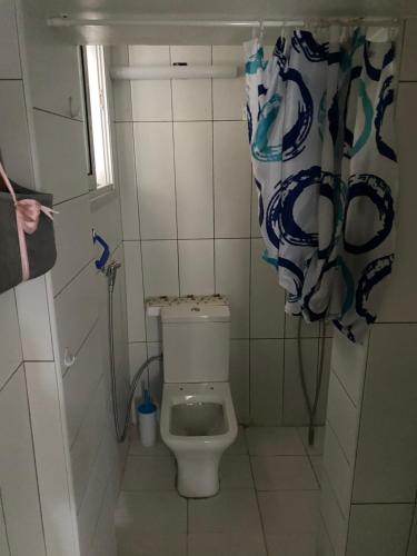 a bathroom with a toilet and a shower curtain at Cozy studio in town center 2 in Limassol