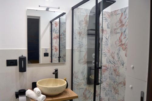 a bathroom with a sink and a shower at Room&Chiaia in Naples
