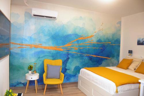 a bedroom with a bed and two chairs at Room&Chiaia in Naples