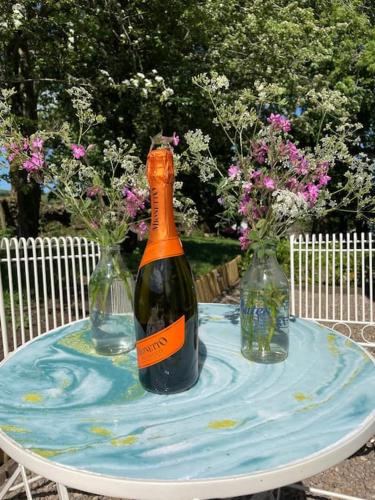 two bottles of wine on a table with flowers at The Rookery in Lothersdale