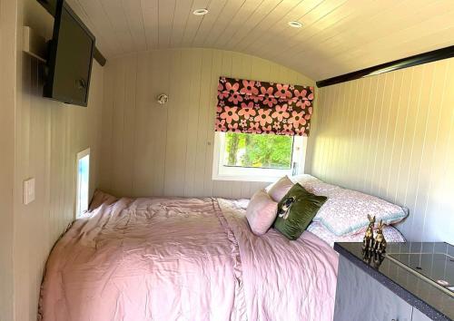 a bedroom with a bed in a small room at The Rookery in Lothersdale