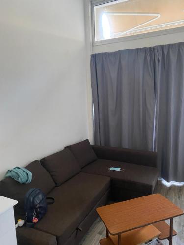 a living room with a couch and a window at Cozy studio in town center 2 in Limassol