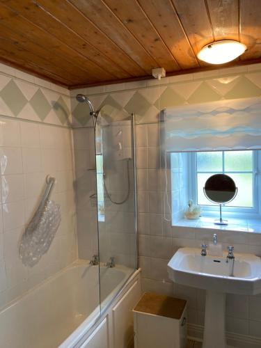 a bathroom with a sink and a shower and a tub at North Farm in Hexham