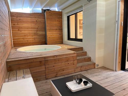 a bathroom with a jacuzzi tub with a table at loft romantique spa in Nice