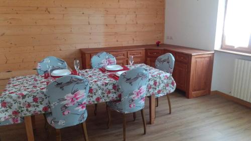 a dining room with a table with blue chairs and a tableablish at Casa Lina in Novate Mezzola
