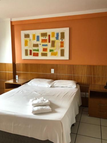 a bedroom with a bed with two towels on it at Porto de Iracema Residence in Fortaleza