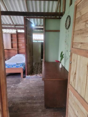 a room with a bedroom with a bed in it at Ecohotel Bahía Terco in Nuquí