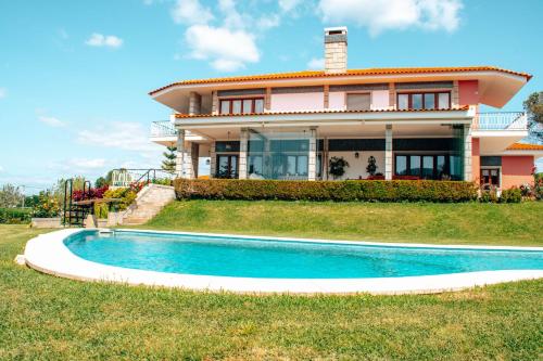 a house with a swimming pool in front of it at Just Like Home - Casa do Rosmaninho in Caminha