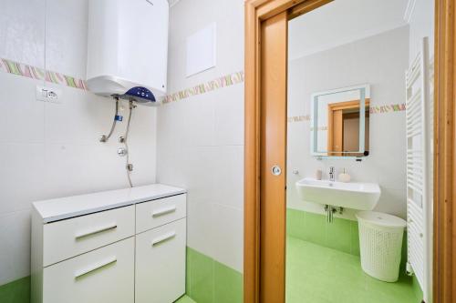 a small bathroom with a sink and a mirror at Supreme Studio Apartment Bijoux in Umag