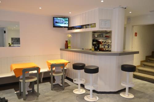 a bar in a restaurant with stools at Hotel St. Gervais in Geneva