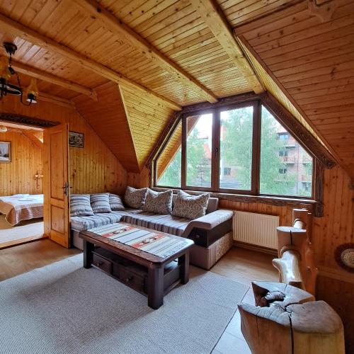 a living room with a couch and a table at Зарінок карпат in Mykulychyn