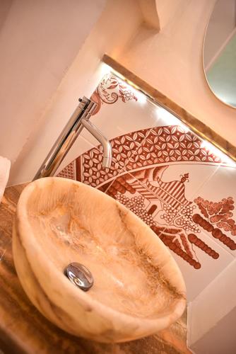 a bathroom sink with a wooden counter top with a tap at B&B Tre Principi in Gallipoli