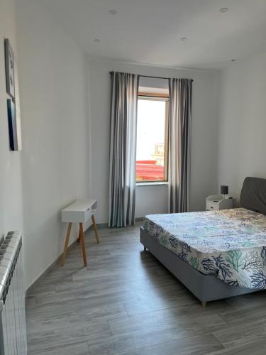 a bedroom with a bed and a window at Elvis Home in Salerno