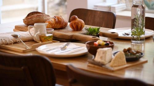 a table with bread and other food on it at Khan Ein Karem Boutique Hotel in Jerusalem