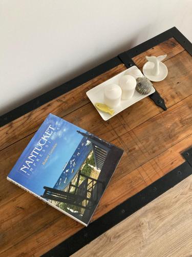 a book sitting on top of a wooden table at Nantucket GuestHouse in Vrbas